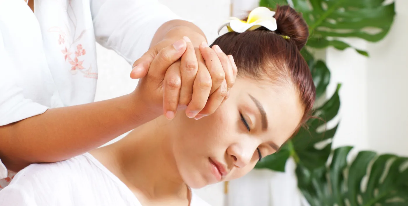 Therapist performing a traditional Thai massage stretch